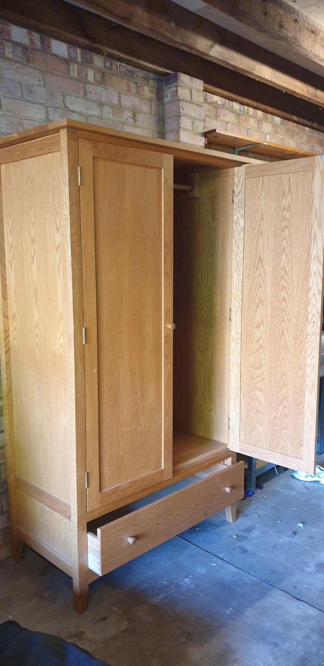 Preview of the first image of Solid oak 2 door wardrobe wooden colour.