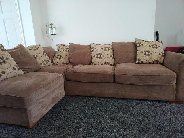 Preview of the first image of Right Corner Sofa with pillows and large footstool.