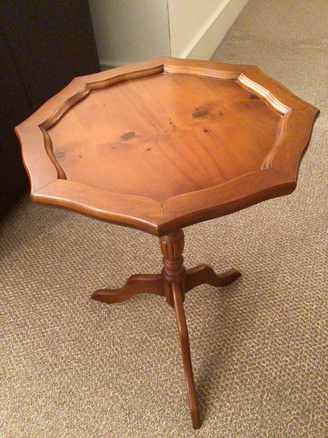 Preview of the first image of A yew wood side table with three legs.
