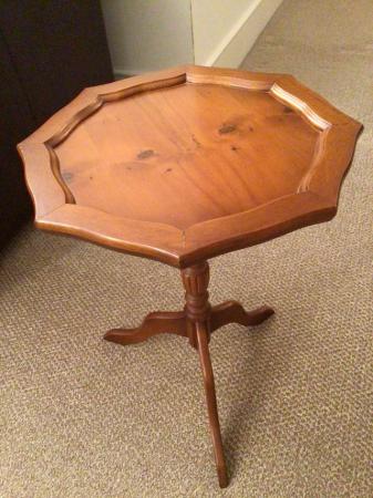 Image 1 of A yew wood side table with three legs
