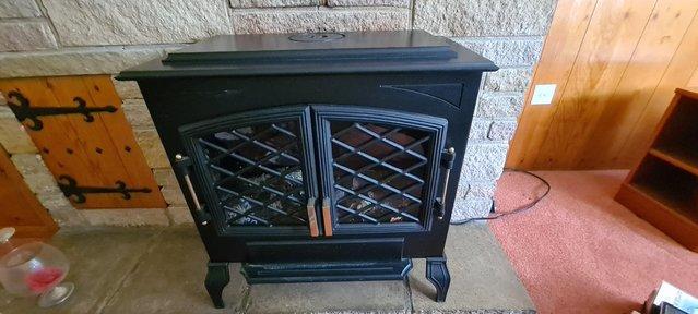 Image 1 of Black iron traditional looking electric fireplace with wood