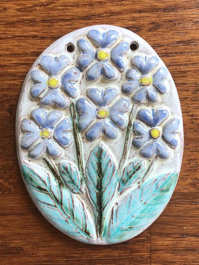 Preview of the first image of Vintage ceramic hanging ornament, flower design. Can post..