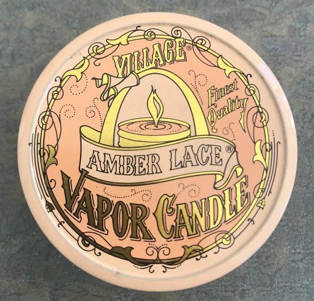 Preview of the first image of Unused Village Amber Lace vapor candle in tin..