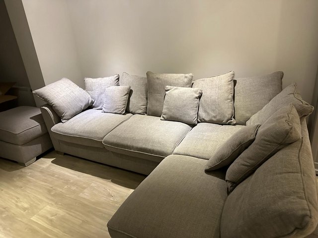Preview of the first image of GREY L SHAPED SOFA WITH SQUARE POUFFE TO MATCH.
