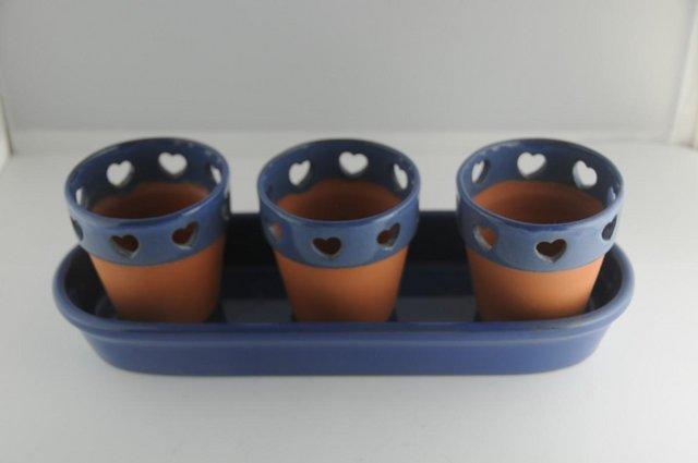 Preview of the first image of Trio Of Indoor Planters With Heart Cut Outs On Tray.