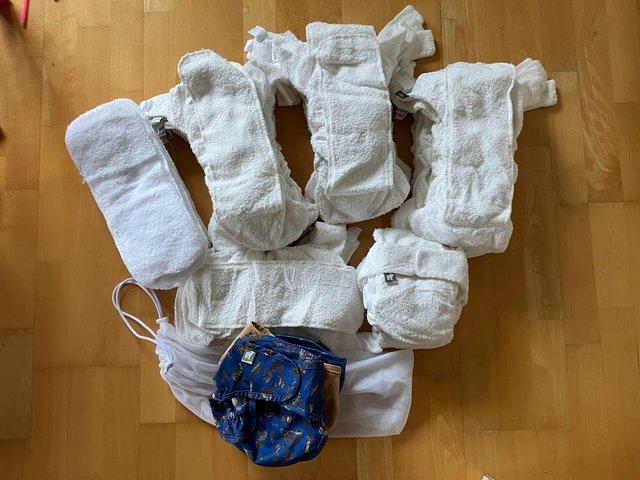 Preview of the first image of 20 Little Lamb Size 2 bamboo no-velcro nappies + 6 wraps.