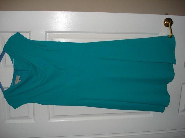 Preview of the first image of Woman's Green Hobbs Dress size 10.
