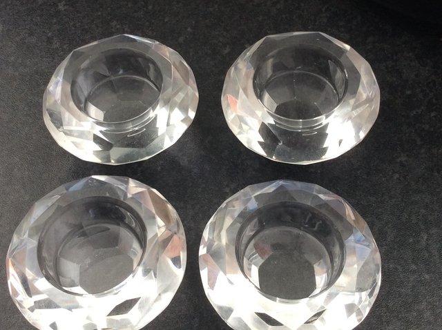 Preview of the first image of 4 crystal glass tea light candle holders.