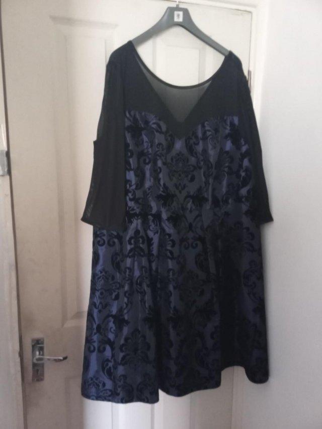 Preview of the first image of Flock Patterned Sheer Yoked Long Sleeve Dress.