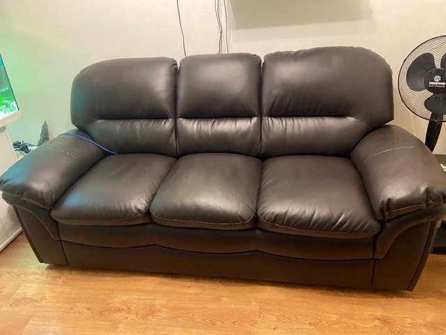 Preview of the first image of Free!! Brown 3 Seater faux leather sofa in good condition.