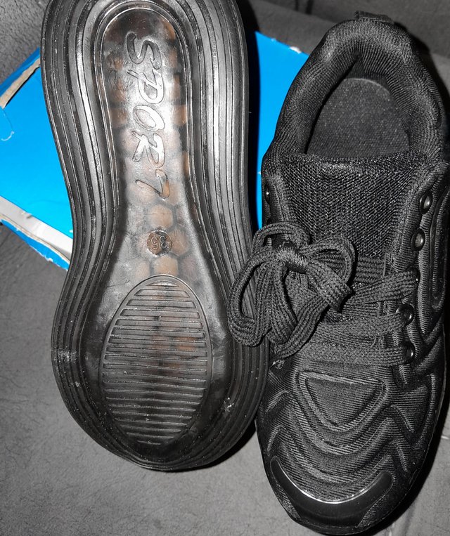 Preview of the first image of Pair of black Trainers size 2.5.