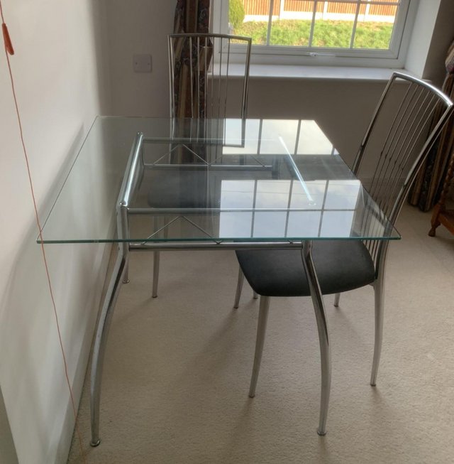 Preview of the first image of Square Glass Dining Table and Two Chairs.