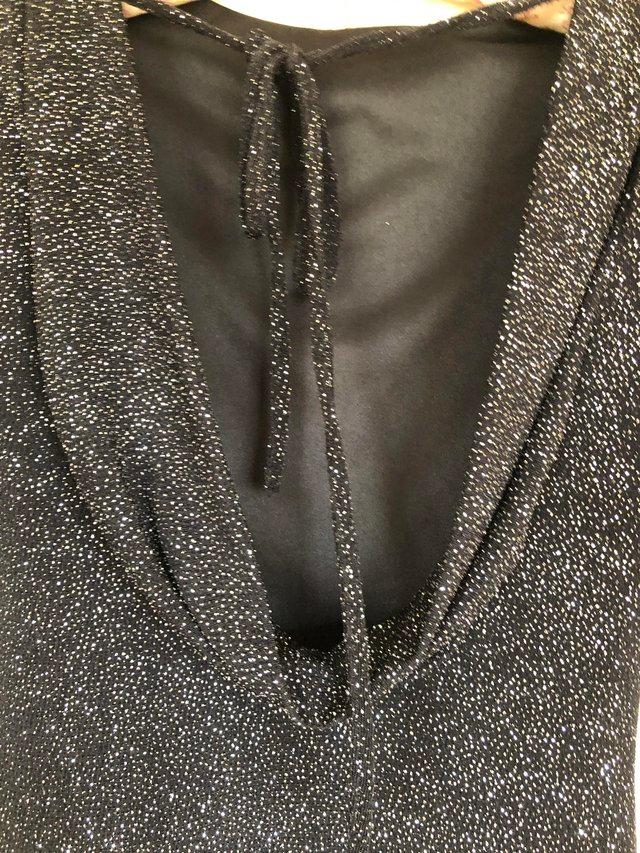 Preview of the first image of Little black party dress with glitter finish.