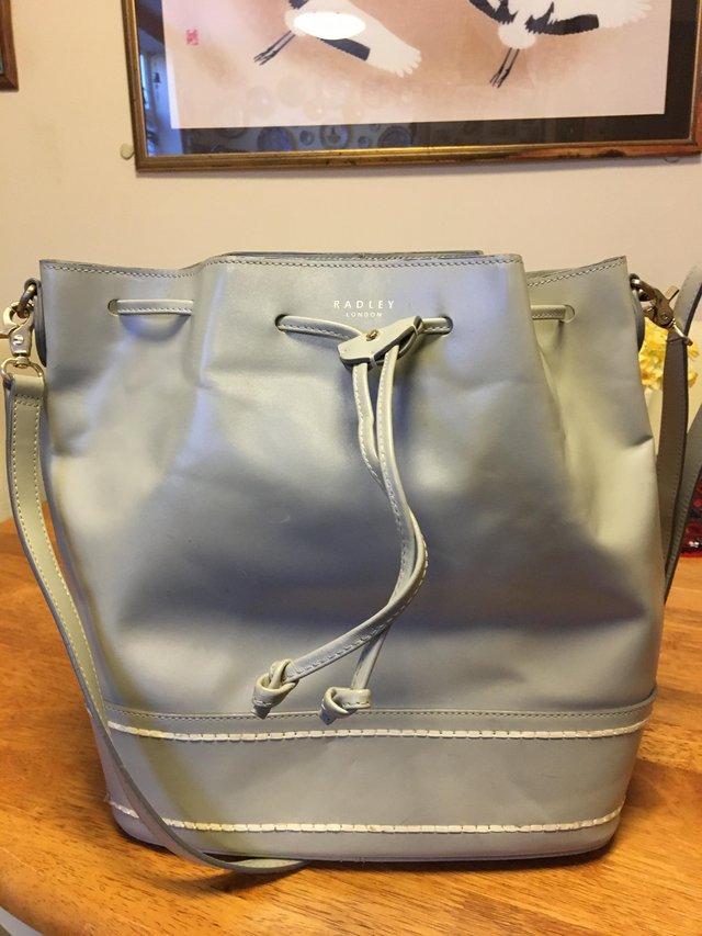 Preview of the first image of Radley grey leather bucket handbag.