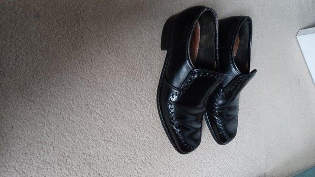 Preview of the first image of Mens Black Leather slip on shoes size 9 with embroided edge.