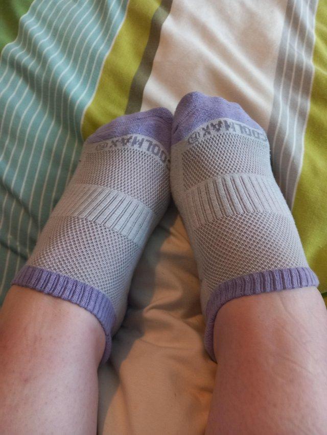 Preview of the first image of Ladies purple and white worn trainer socks.