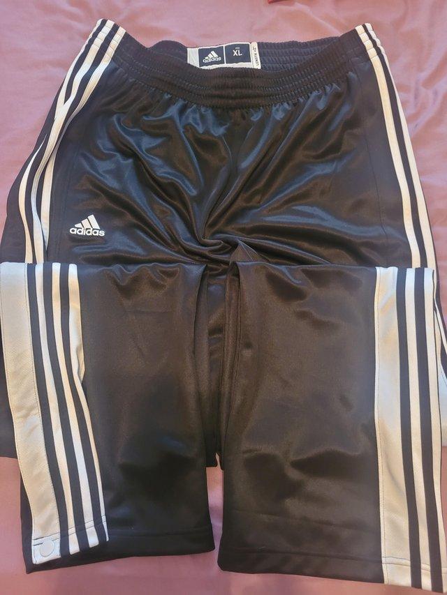 Preview of the first image of Adidas tracksuit bottoms.