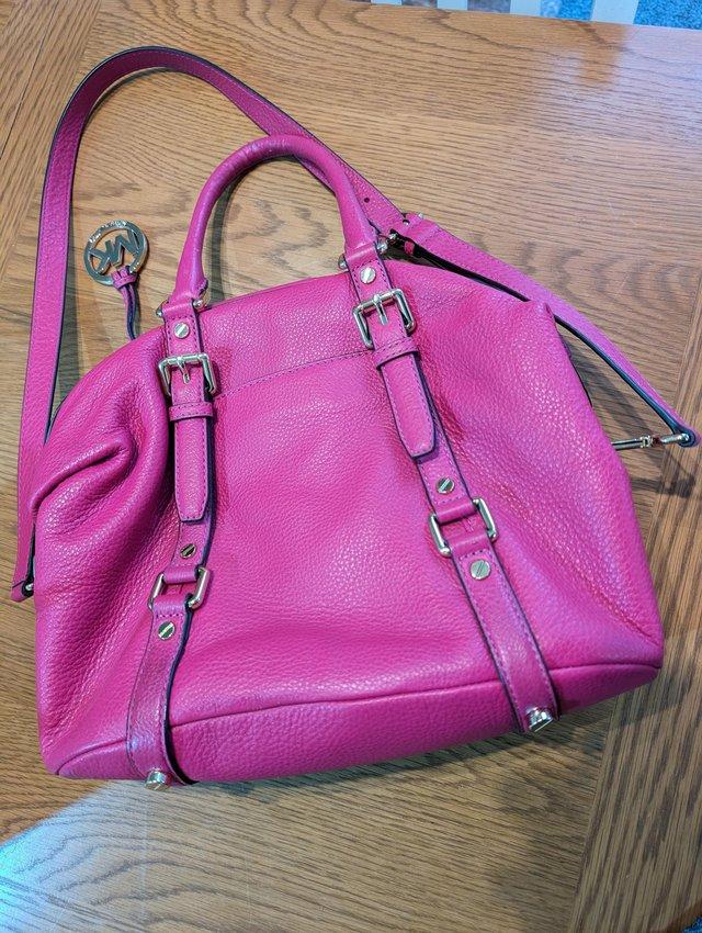 Preview of the first image of Genuine Michael Kors leather hot pink handbag.