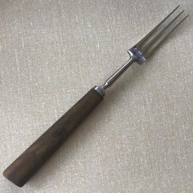 Preview of the first image of Vintage meat fork, stainless steel + wooden handle..