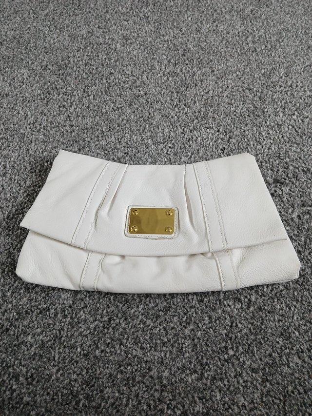 Preview of the first image of Ladies white clutch bag.