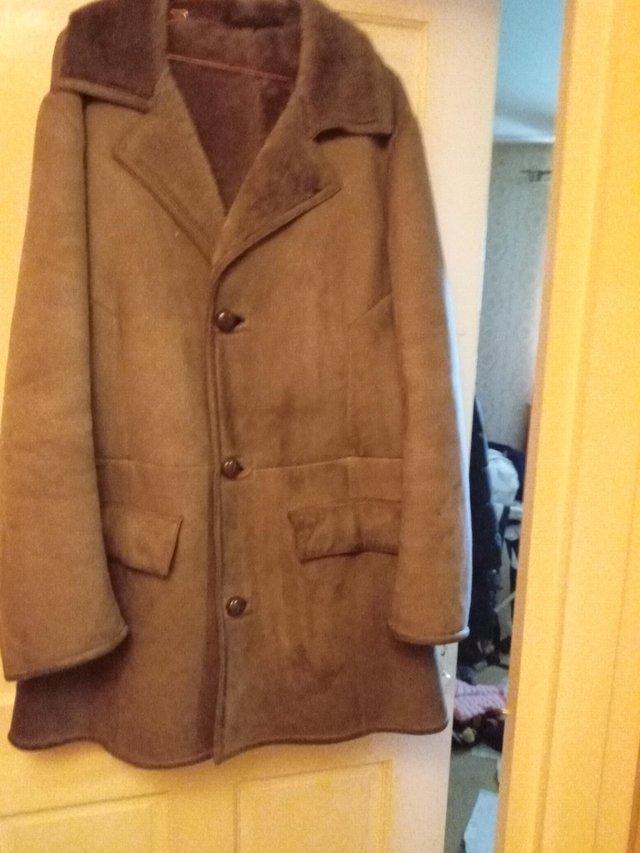 Preview of the first image of Men's genuine sheepskin coat styled.