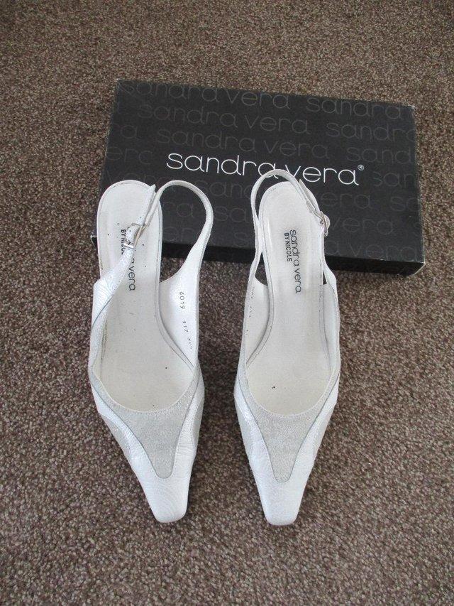 Preview of the first image of Sandra Vera shoes and matching clutch bag..