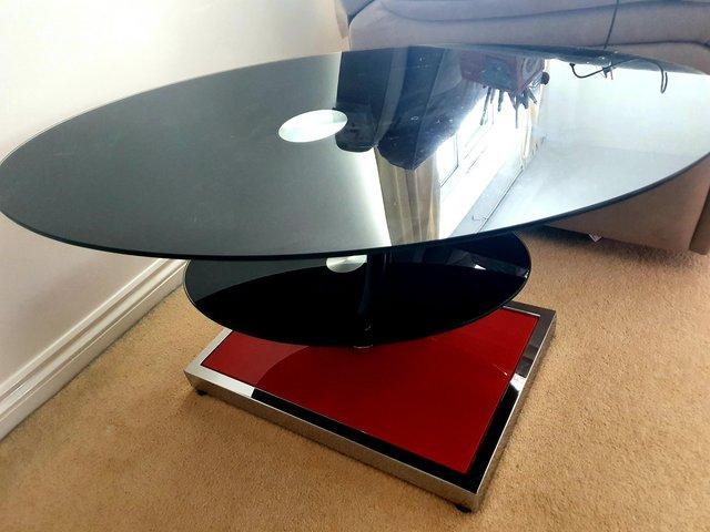 Preview of the first image of Oval swivel coffee table, black and red.
