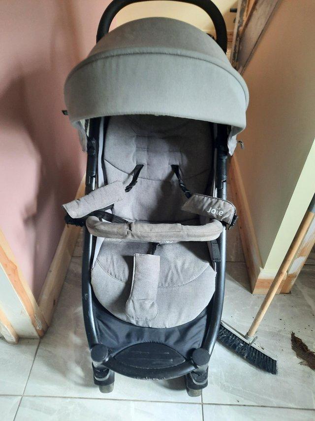 Preview of the first image of Joie pushchair with raincover.