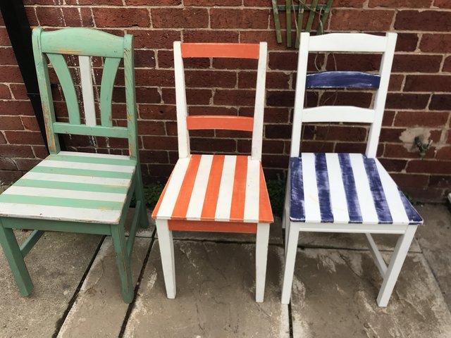 Preview of the first image of Upcycled brightly-painted kitchen chairs.
