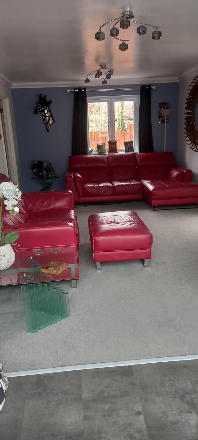 Preview of the first image of Dfs red leather sofas and footstool.