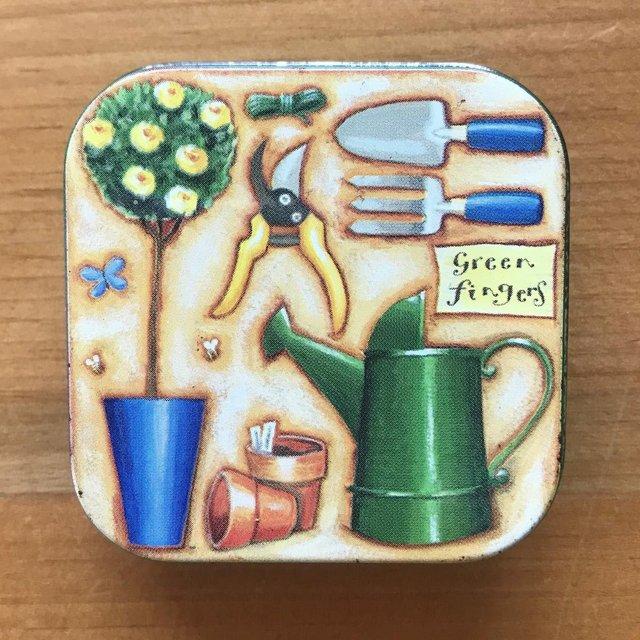 Preview of the first image of Small square 'green fingers' tin with garden design lid..