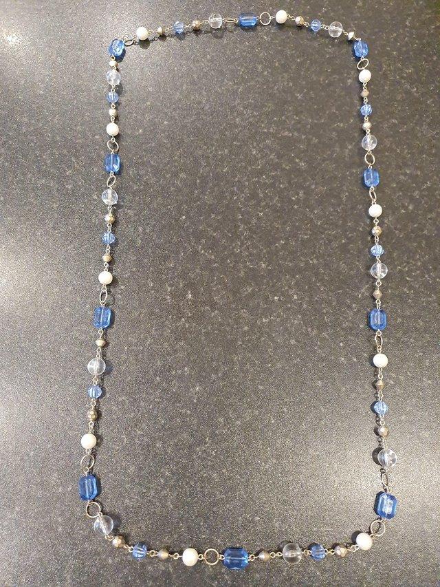 Preview of the first image of Blue & white bead necklace on a silver coloured chain.