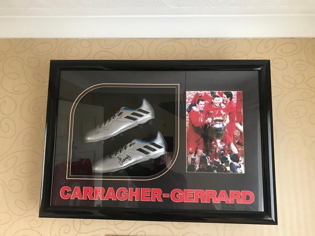 Preview of the first image of Signed and Framed Jamie Carragher and Steve Gerrard Boots.