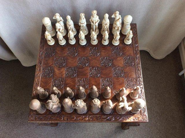Preview of the first image of Moulded resin chess table and chessmen.