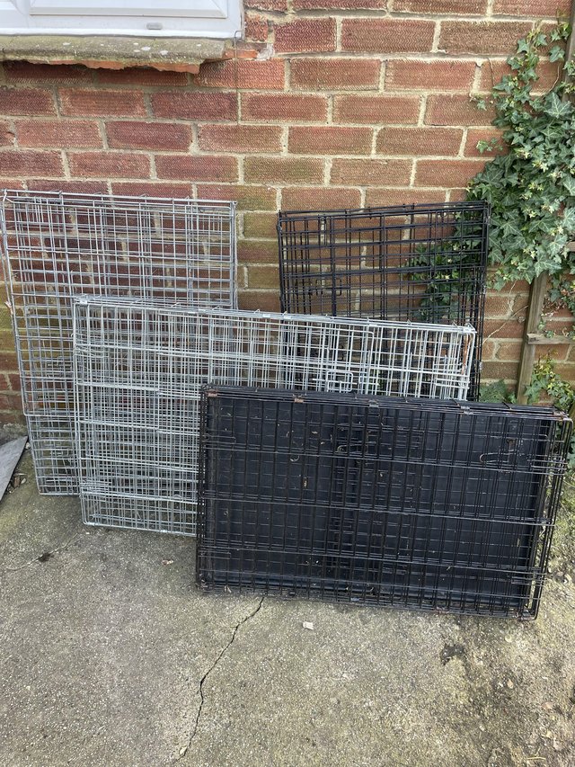 Preview of the first image of 2 L dog crates , 1 medium sized.
