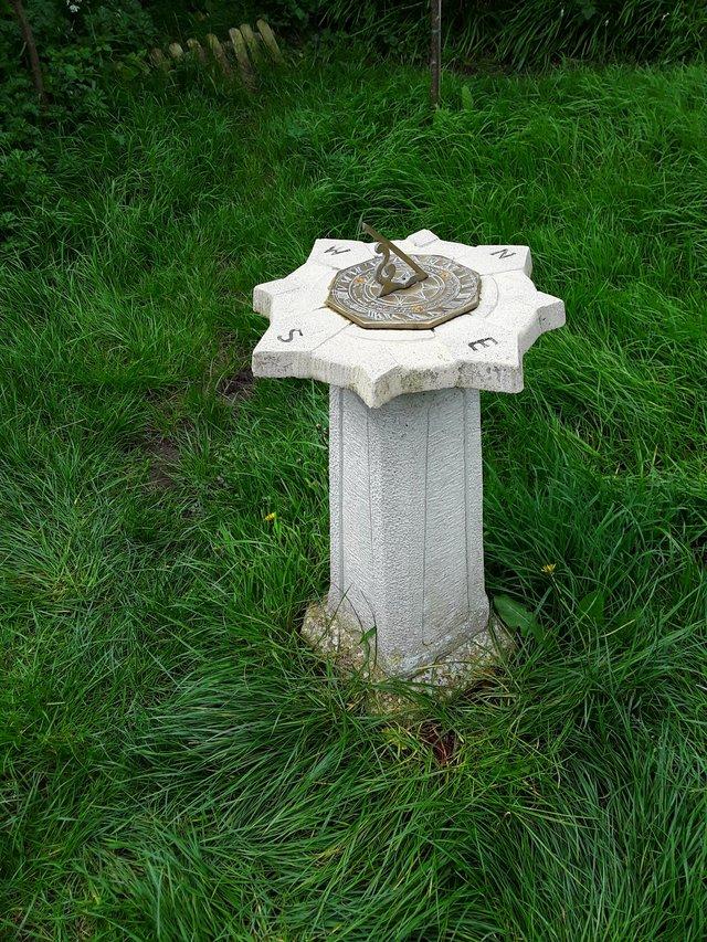 Preview of the first image of Brass sundial on stone plinth.