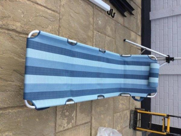 Image 1 of A foldable Sun Lounger with a head rest