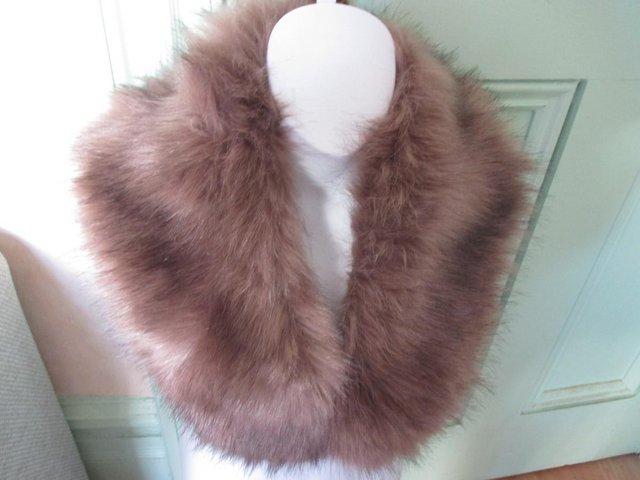 Preview of the first image of FAUX FUR SHOULDER WRAP WITH PINK TINGE.