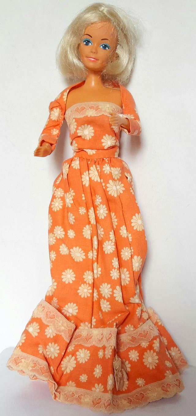 Preview of the first image of 1990,s DOLL by LUCKY in ORANGE DRESS 30 cm tall.