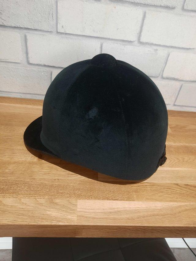 Preview of the first image of Black champion riding hat size 7 1/4.