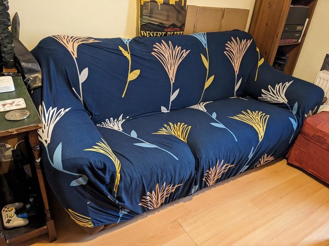 Preview of the first image of Navy blue patterned 4-seat sofa cover.