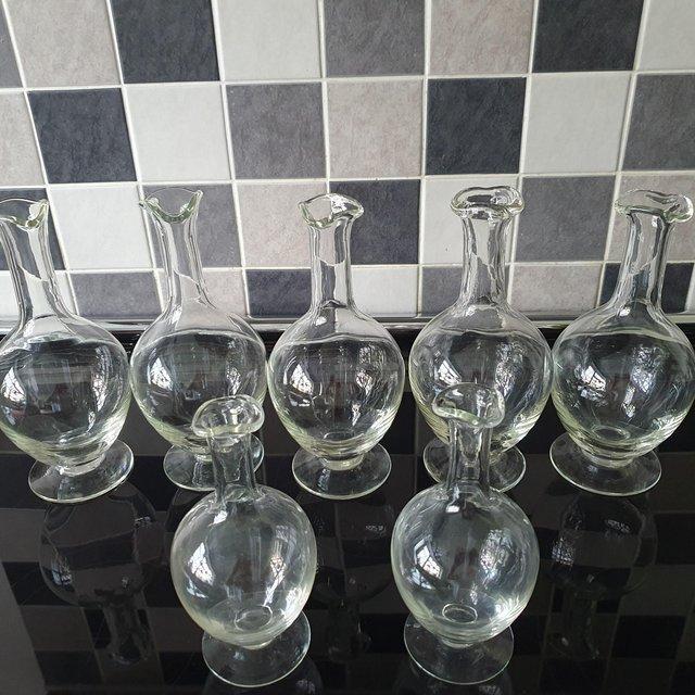 Preview of the first image of Clear Glass hand-blown carafes 5 large 2 small.