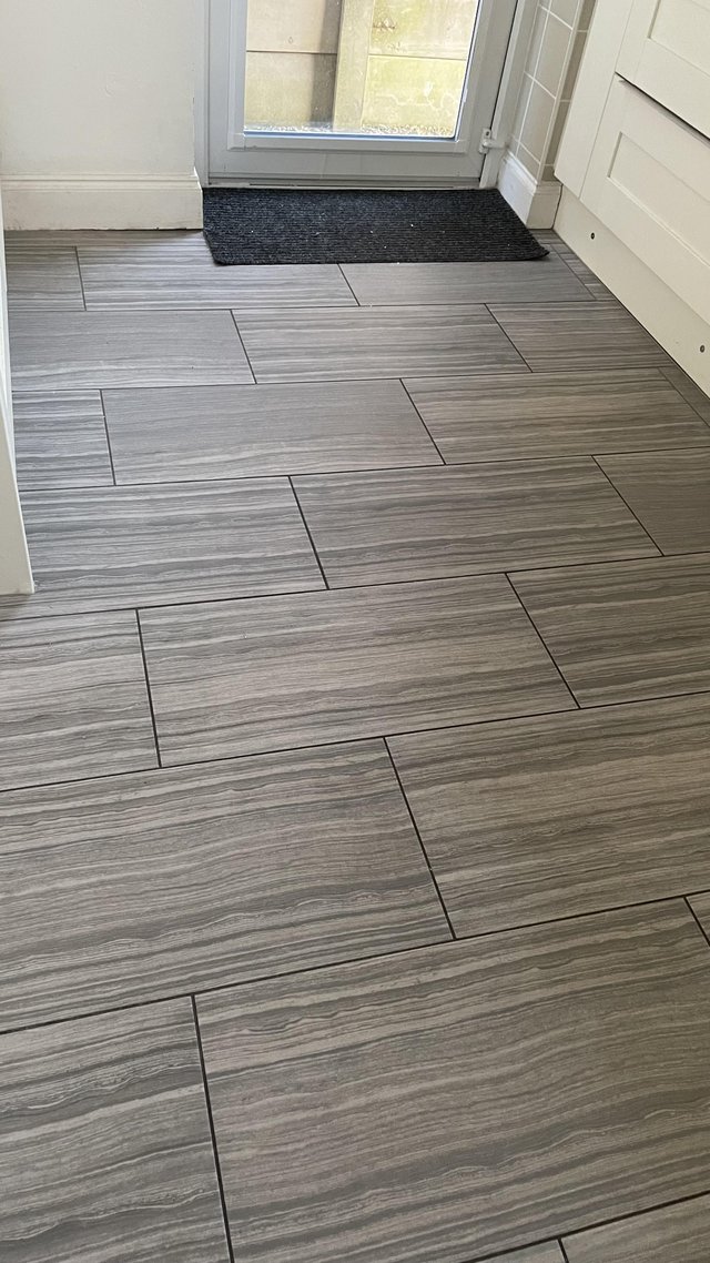 Preview of the first image of 9 brand new porcelain floor tiles - grey coloured.