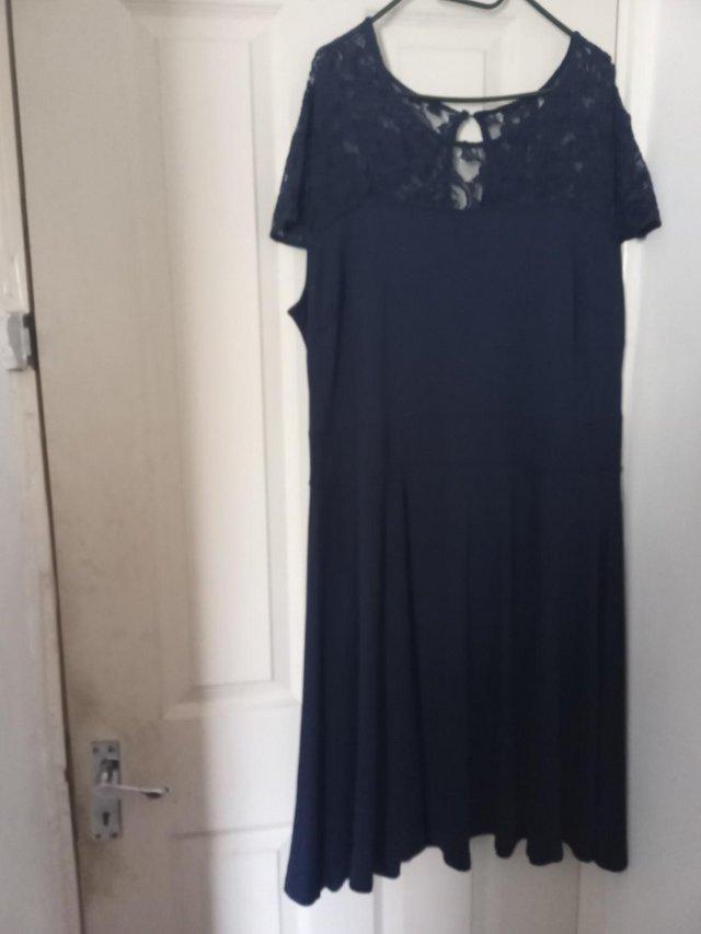 Preview of the first image of Navy Lace Yoke Dress short sleeve cap.