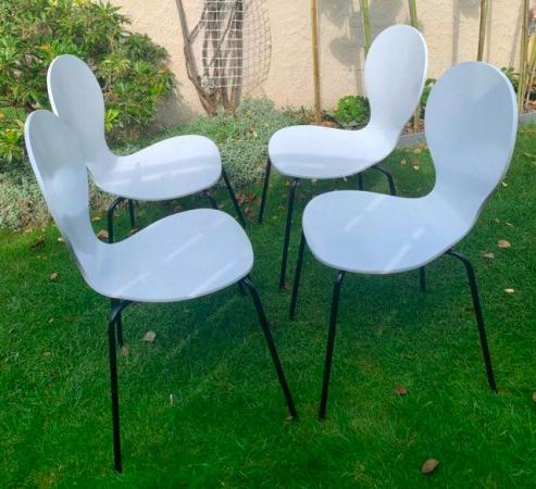 Image 2 of A set of four modern kitchen dining chairs.