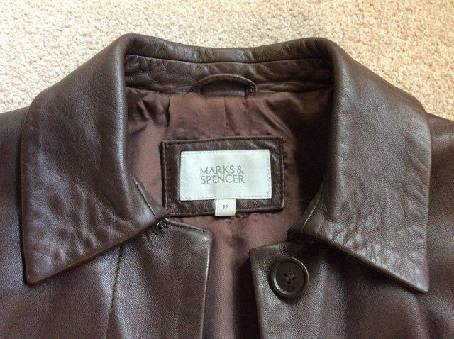 Preview of the first image of Ladies M&S brown leather knee-length coat, size 12.