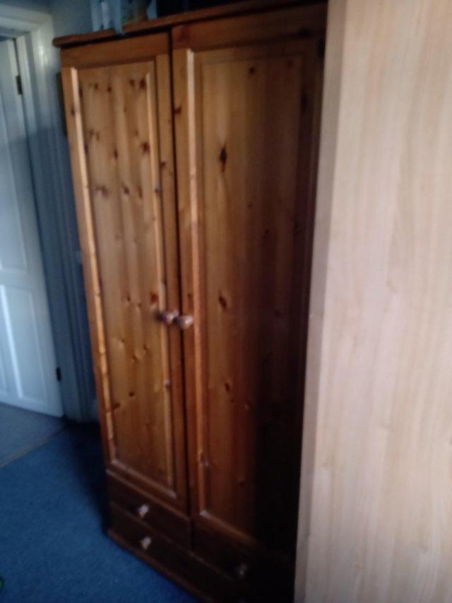 Preview of the first image of Wardrobe antique pine with bunfeet.