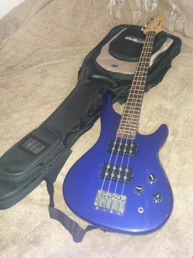 Preview of the first image of Bass Guitar, Wesley, with New padded case. Tuner. New stand.