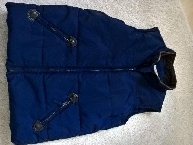 Preview of the first image of John Lewis boy's quilted navy gilet age 11.