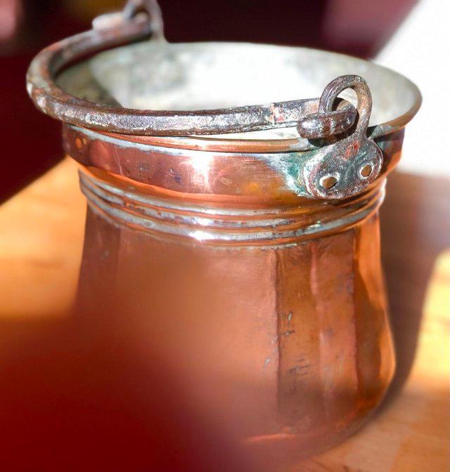 Preview of the first image of HEAVY ANTIQUE COPPER CAULDRON WITH WROUGHT IRON HANDLE.